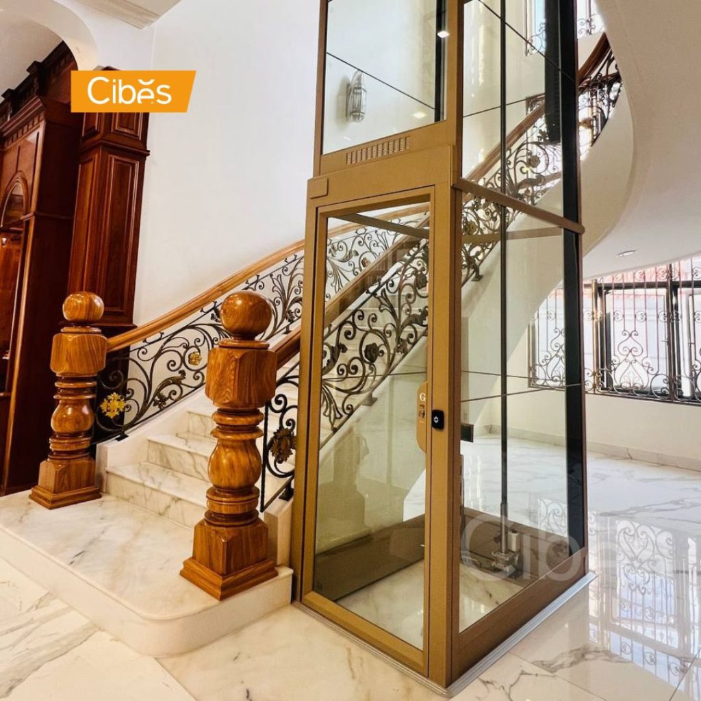 Pitless home elevator with a glass shaft installed in a luxury villa.